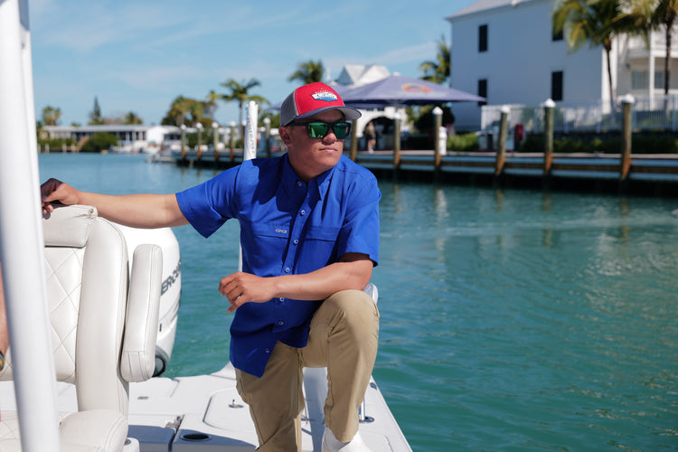 Man on boat wearing patch cap and classic microfiber shirt