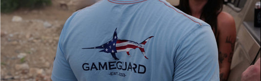 Man Wearing GameGuard RainWater T-Shirt standing in front of a person