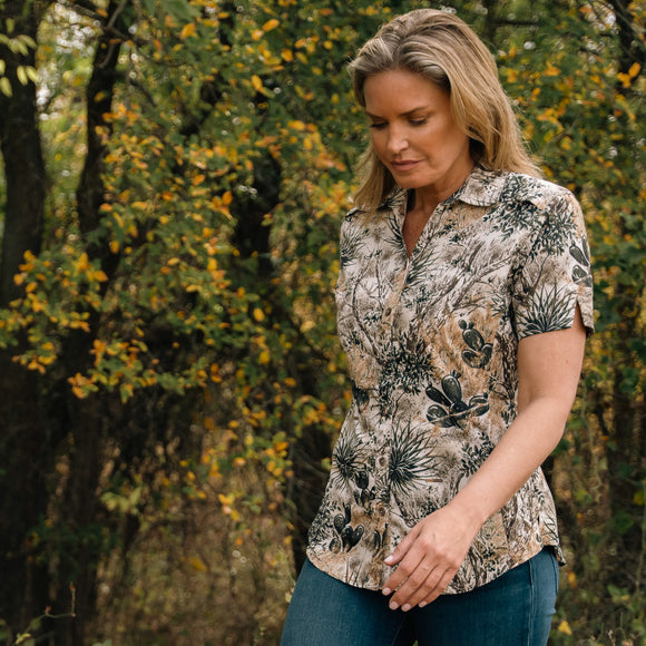 woman walking through woods outdoors wearing gameguard shirt