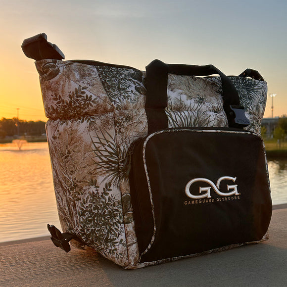 Caviar GameGuard Cooler sitting in front of a lake