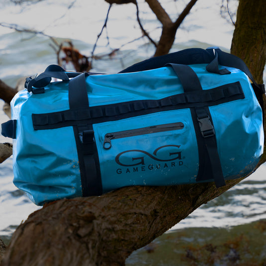 Marine DryDuffle sitting on a tree branch in the outdoors over water
